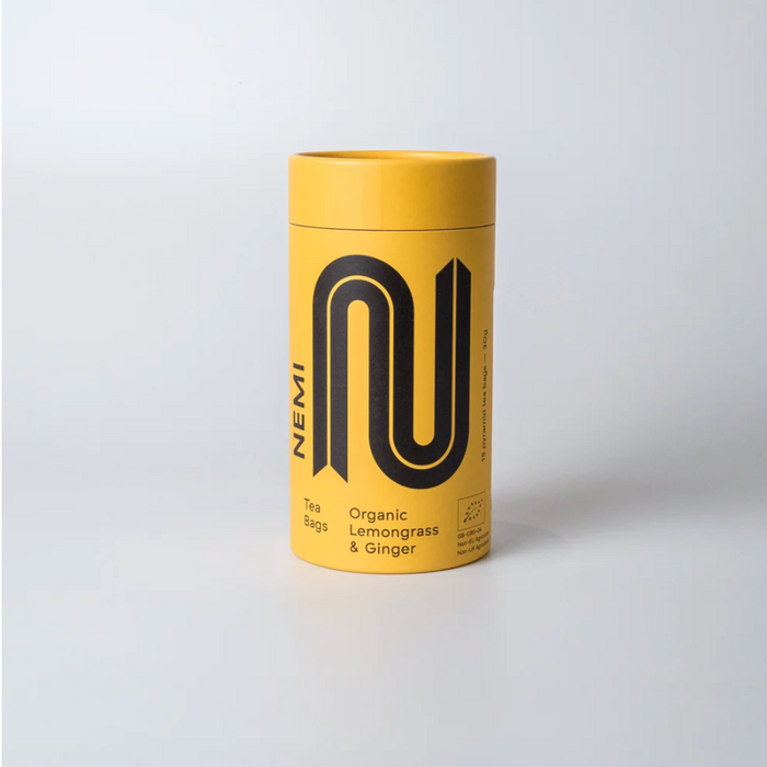 Yellow cylindrical Nemi tea Lemongrass & ginger container with black logo and text on a white background