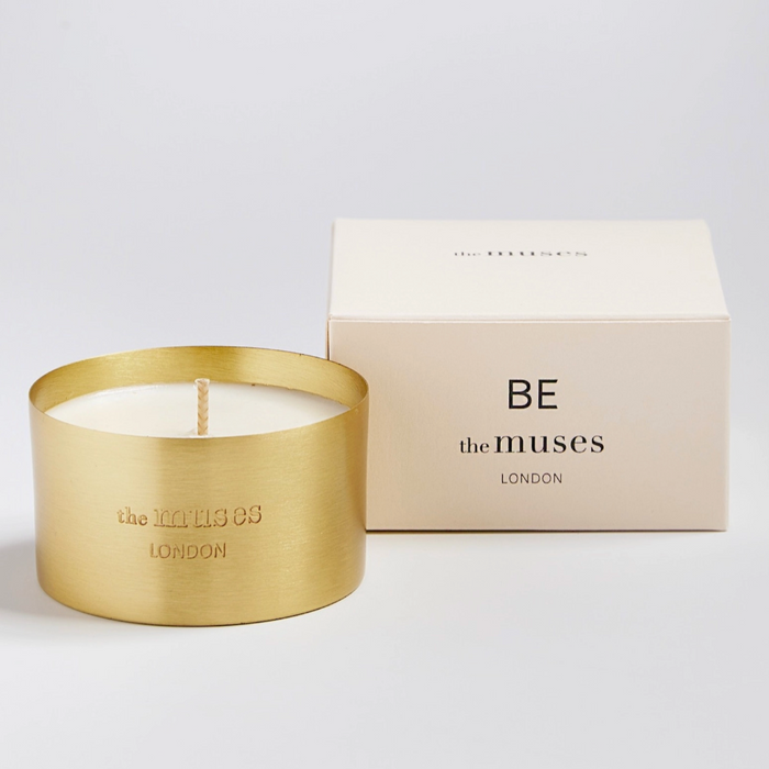 small candle in brass vessel with box and white background