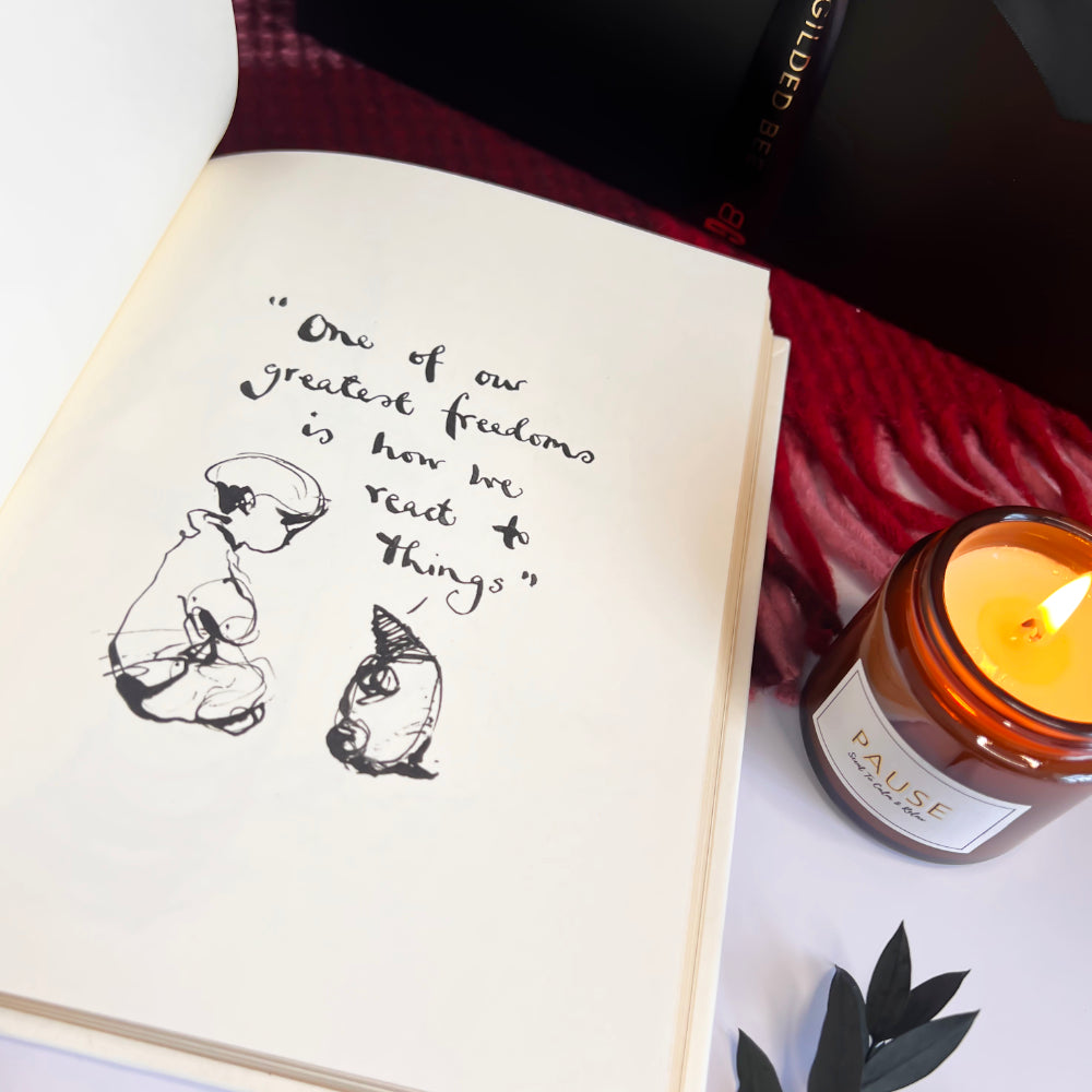 Open book with a quote and illustrations next to a lit candle labeled 'Pause'.
