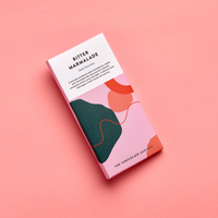 Chocolate bar packaging with abstract designs on a pink background