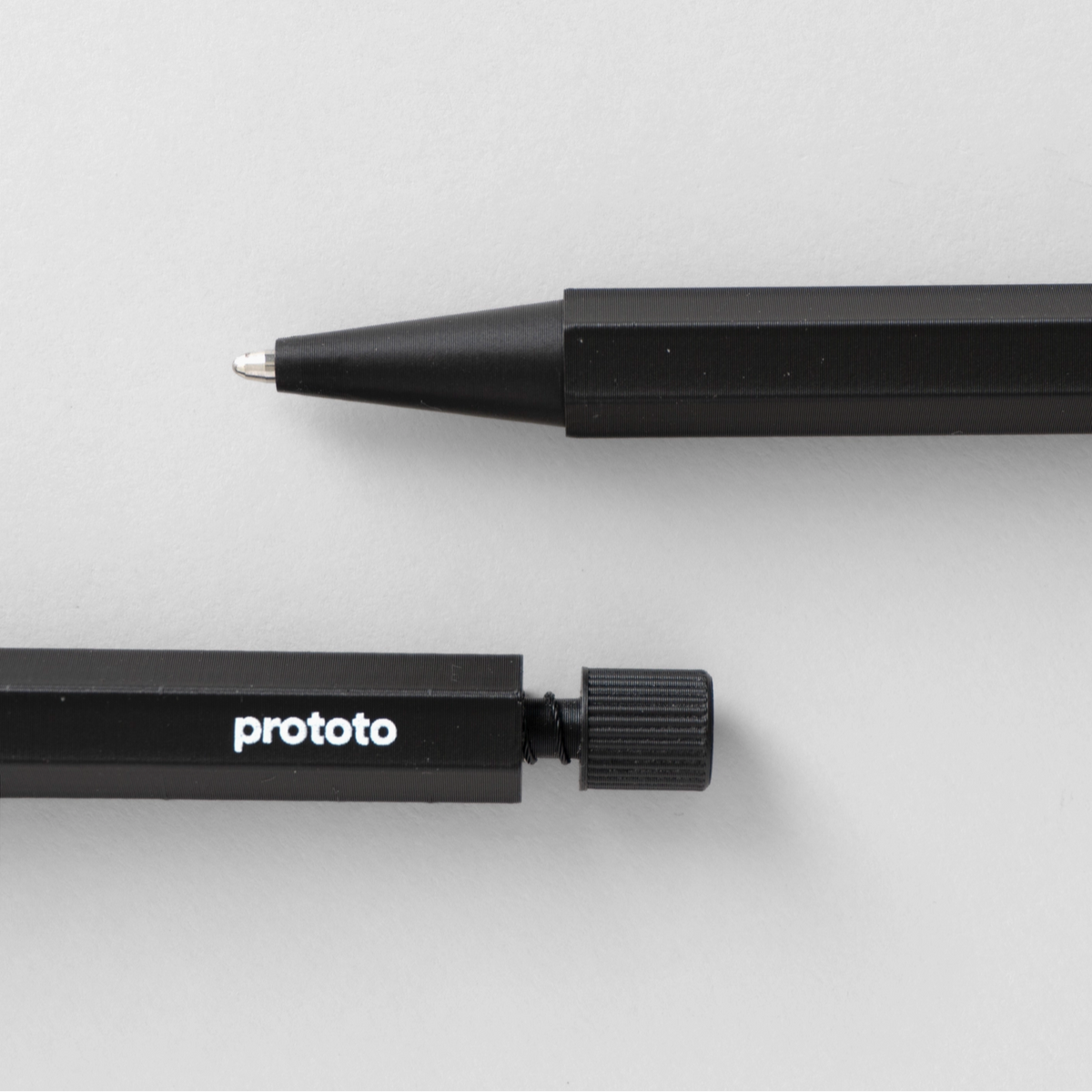Black pen with 'prototo' branding on a light gray background