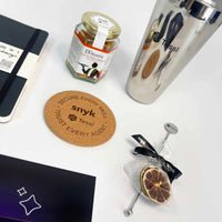 Collection of items including a phone, jar, glass, and coasters with 'snyk' branding on a white surface.