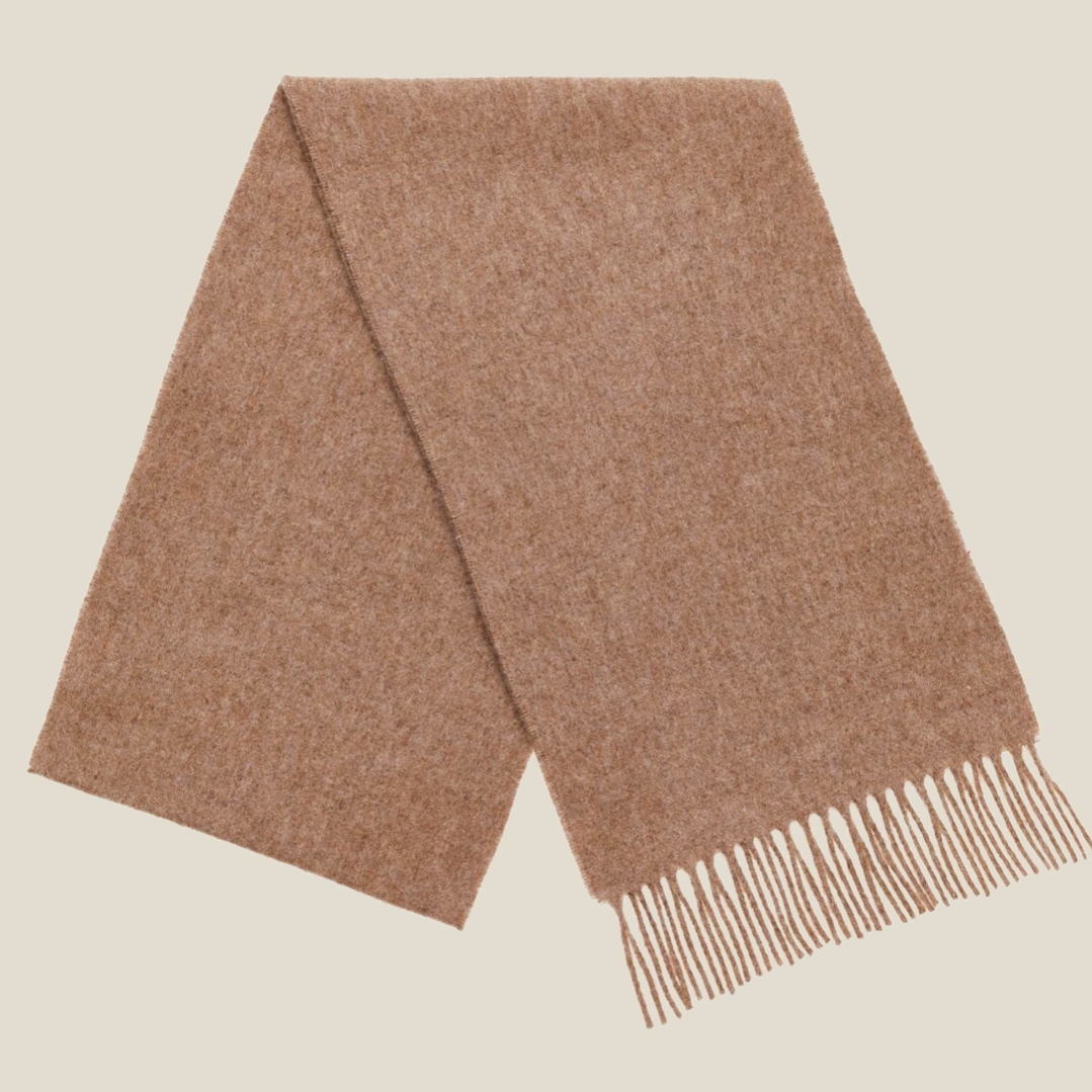 Caramel colour merino wool scarf on white background 