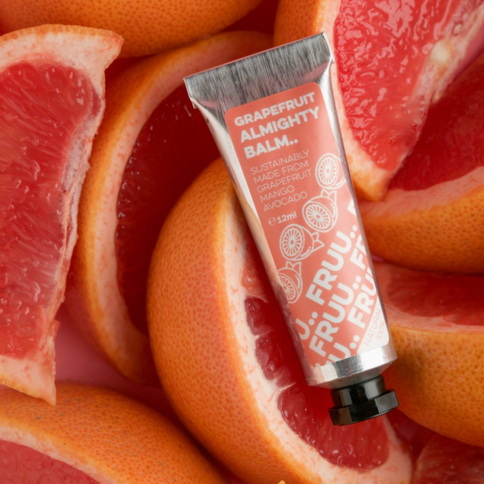 Grapefruit Almighty Balm surrounded by grapefruit slices