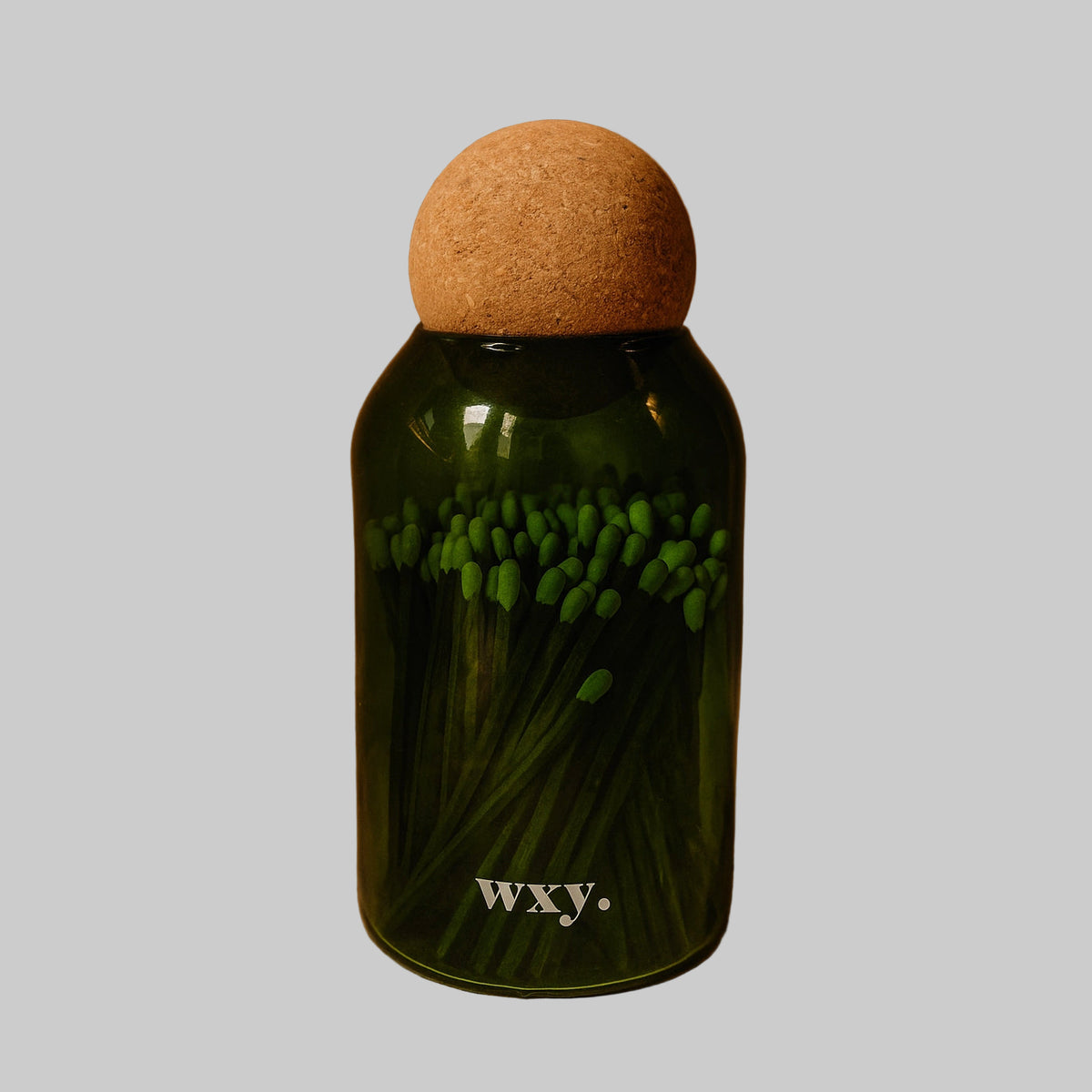Green bottle with cork lid on a brown background