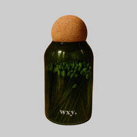 Green bottle with cork lid on a brown background