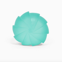 A mint green silicone pet chew toy with a segmented, flower-like design, photographed on a clean white background.
