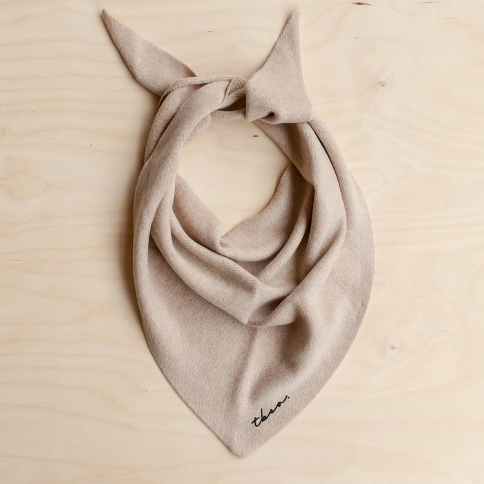 Beige scarf with a knot on a beige background