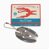 A compact multi-tool keychain shown in front of its retail box on a plain white background. The tool is metallic silver with a chain attached, and the box features a red and blue design with the text 'Mini Multi-Tool with Handy Pouch' and '7 Tools'.