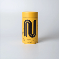 Yellow cylindrical Nemi tea Lemongrass & ginger container with black logo and text on a white background