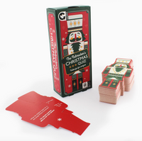 The Nutcracker's Christmas Quiz card game set on a white background, showing the green and red illustrated game box, a red card, and stacks of cards shaped like The Nutcracker.