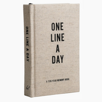 A five-year memory book with a textured beige linen cover and black text reading 'ONE LINE A DAY' on the front and spine, shown on a plain white background.