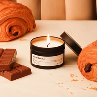 Pain Au Chocolat Candle by Wick Guru with chocolate in the background