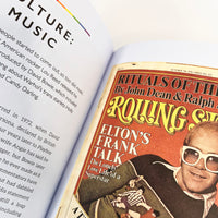 Open book with a Rolling Stone magazine cover featuring Elton John on the right