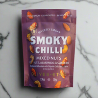 Packet of smoky chilli mixed nuts on marble background