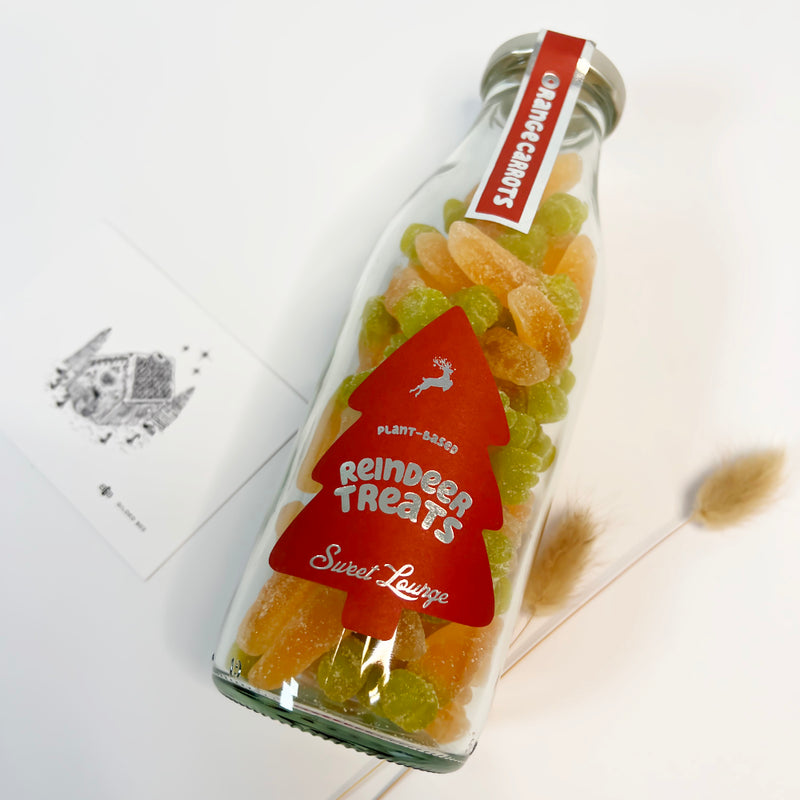 Bottle of reindeer treats with a red label on a white background