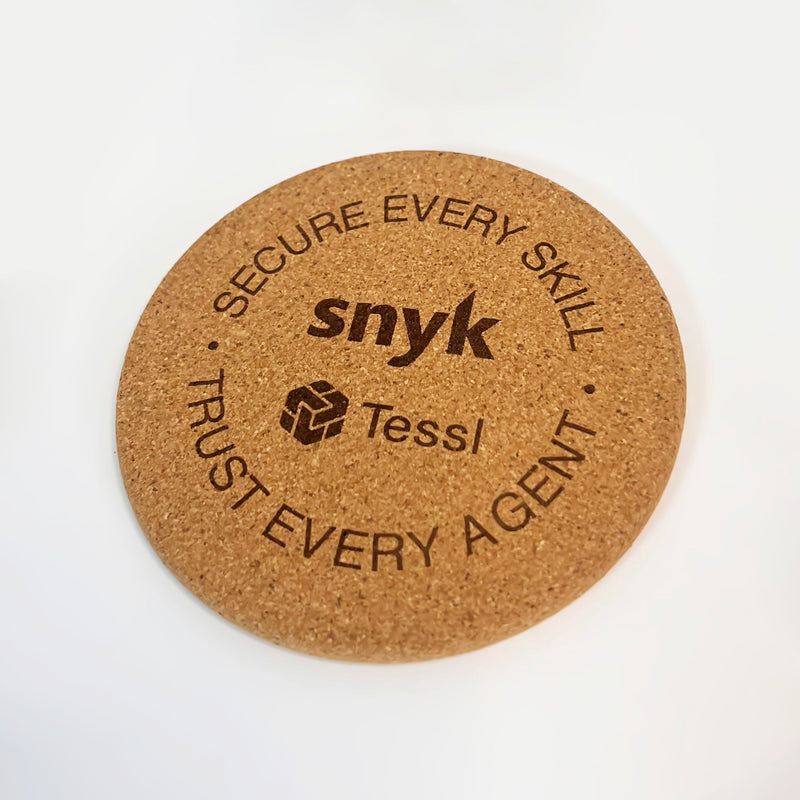 Round cork coaster with 'snyk' and 'Tessl' branding on a white background
