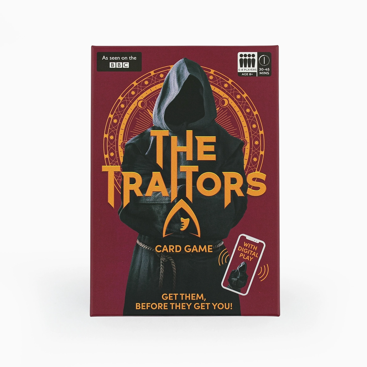 The Traitors card game box featuring a dark hooded figure with the title in large gold letters on a burgundy background, with a small BBC logo and age rating shown on the packaging.
