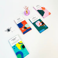 Colorful product packages with abstract designs on a white background