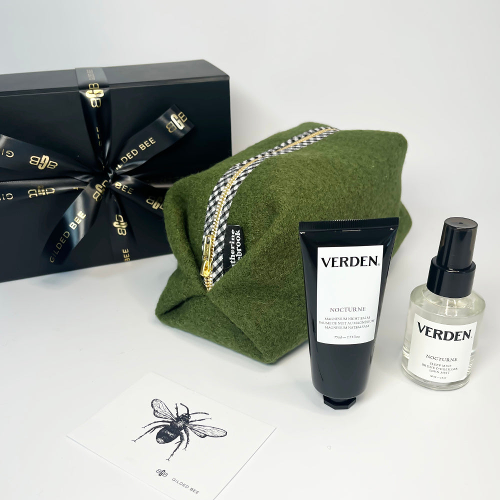 Washbag in olive green with verden products in front and black gift box tied with Gilded Bee ribbon