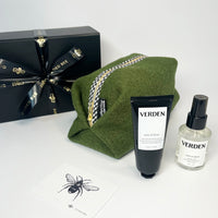 Washbag in olive green with verden products in front and black gift box tied with Gilded Bee ribbon