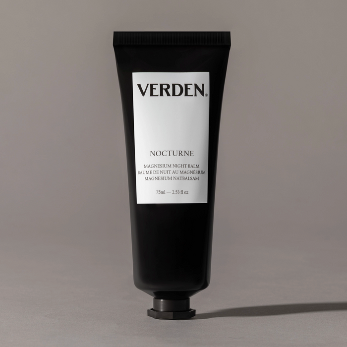Black tube of Verden Nocturne balm on a gray background