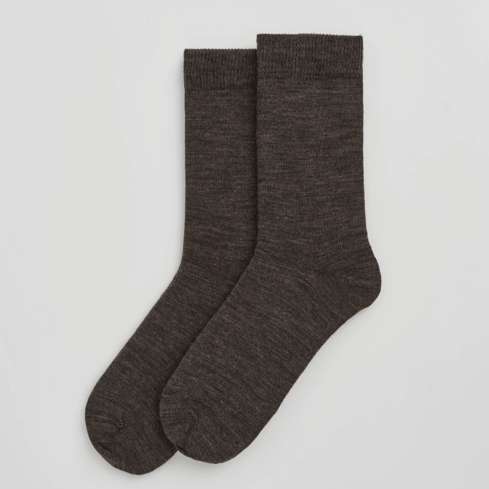 Pair of brown socks on a light grey background