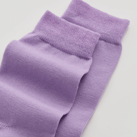 Pair of purple socks on a light gray background