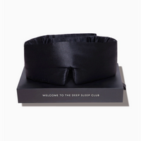 Black satin eye mask on a branded box with 'Welcome to the Deep Sleep Club' text.