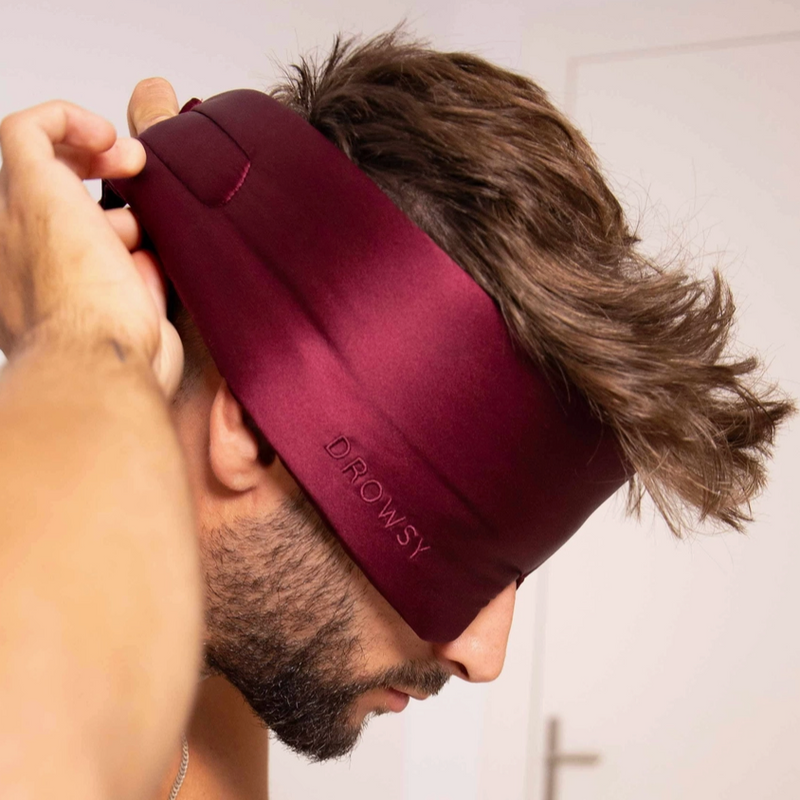 Person wearing a maroon headband with 'DROWSY' branding, against a neutral background.