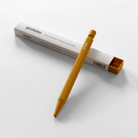 Mustard yellow prototo pen leaning against box on white background 