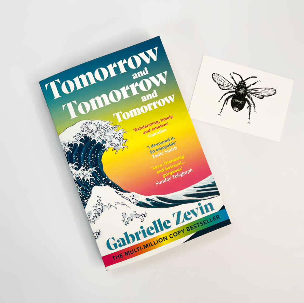 Book titled 'Tomorrow and Tomorrow and Tomorrow' by Gabrielle Zevin on a white background
