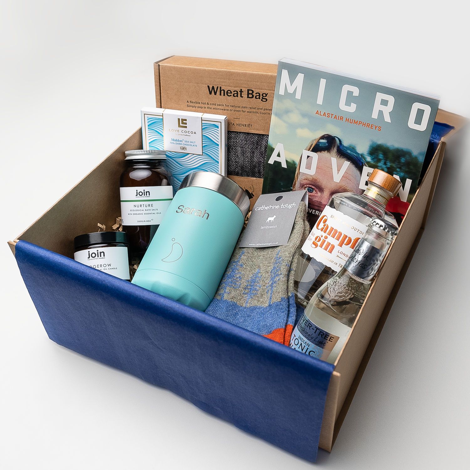 Wellbeing corporate gifts including Micro Adventures by Alastair Humphreys, Join bath salts and candle and Love Cocoa chocolate