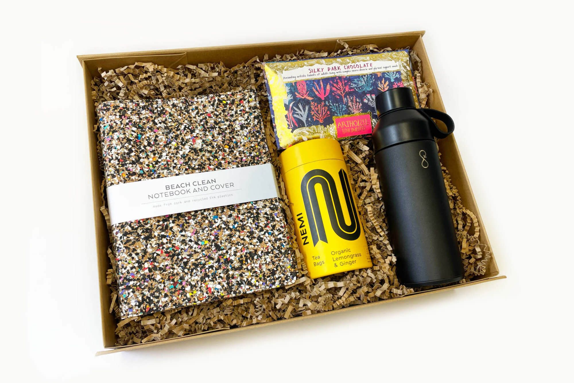 New year corporate gifts including a Beach Clean notebook, Nemi Teas, Arthouse chocolate and an Ocean Bottle
